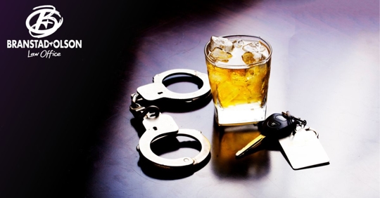 Alcoholic drink near handcuffs and car keys