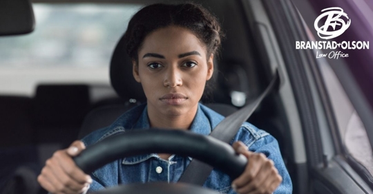 Black woman behind the wheel of a vehicle
